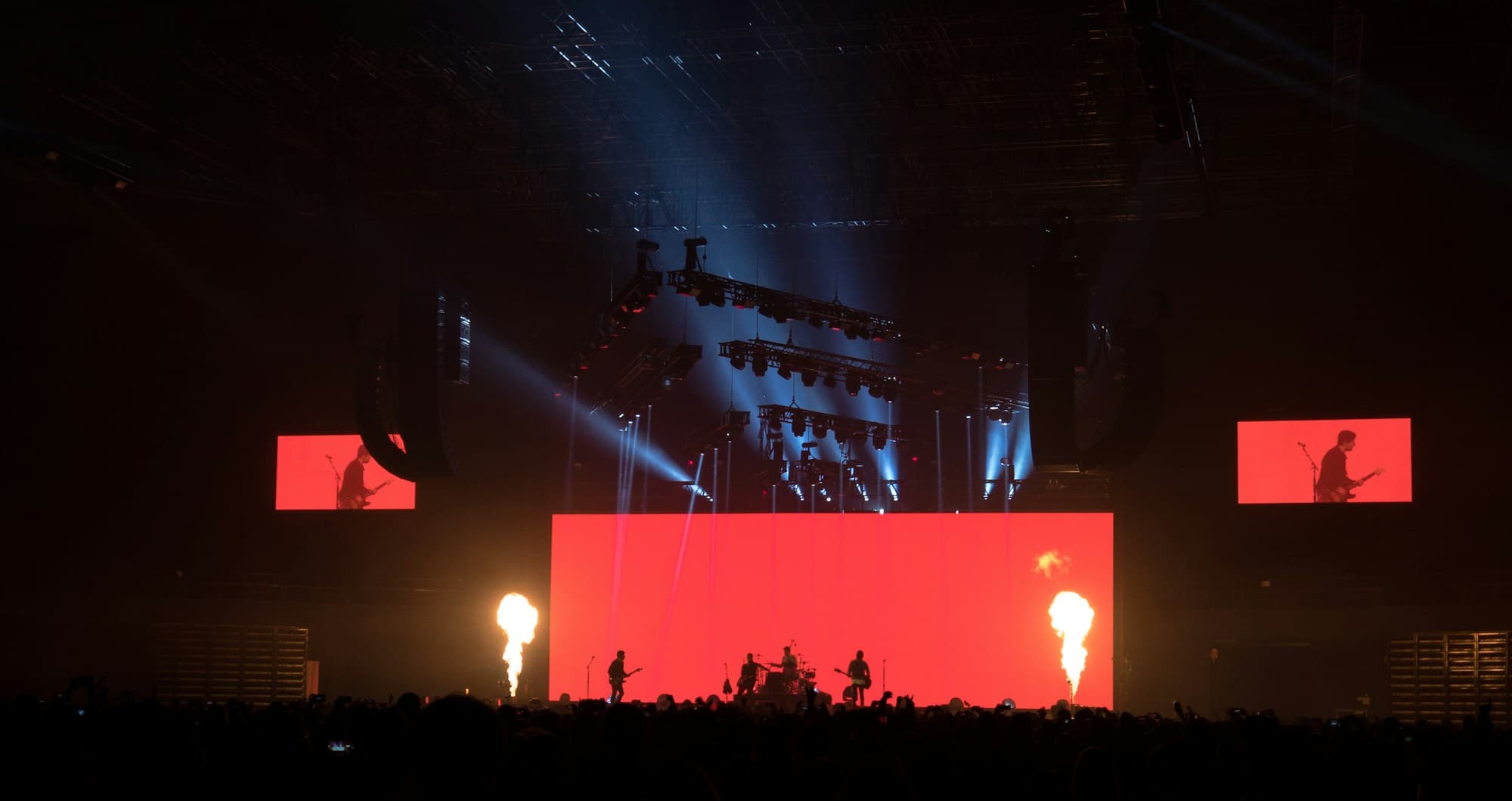 A concert stage backed by a massive illuminated LED screen
