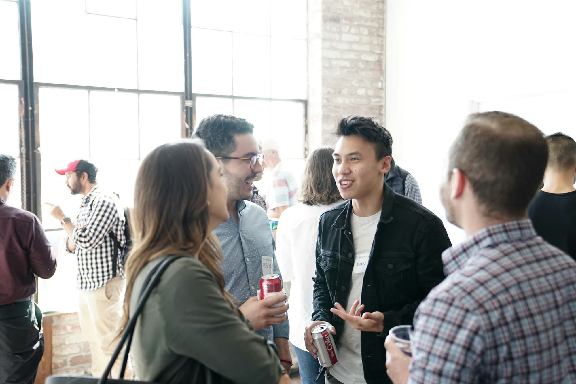 Guests mingle and talk in an open lobby after a session