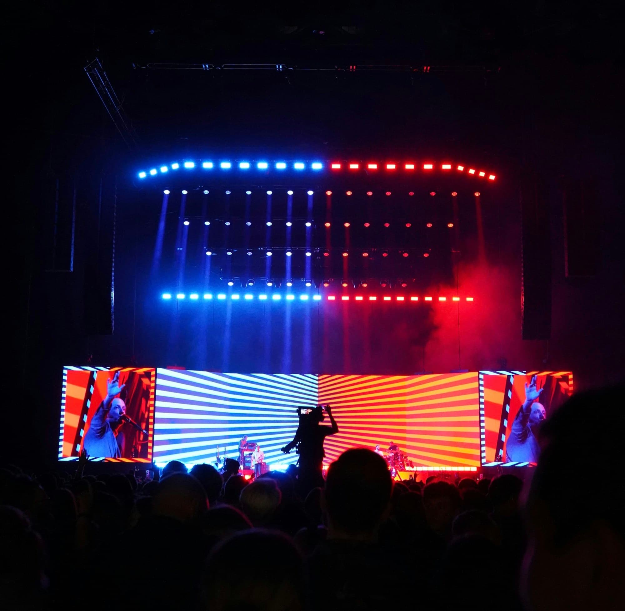 A large arena stage lit with an expansive LED backdrop