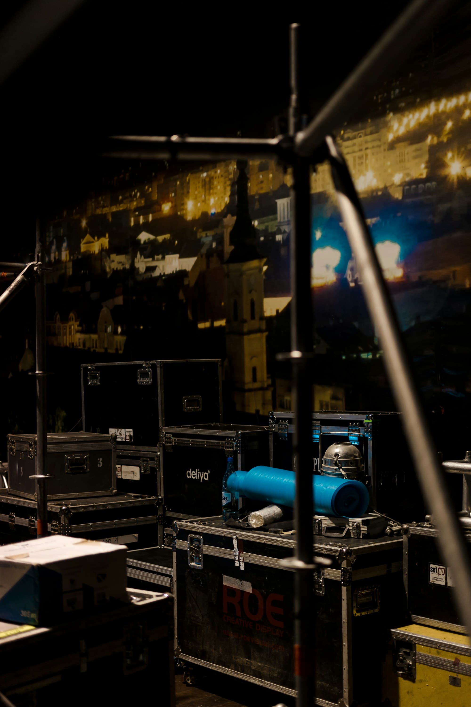 Stacked flight cases backstage before a production load-in