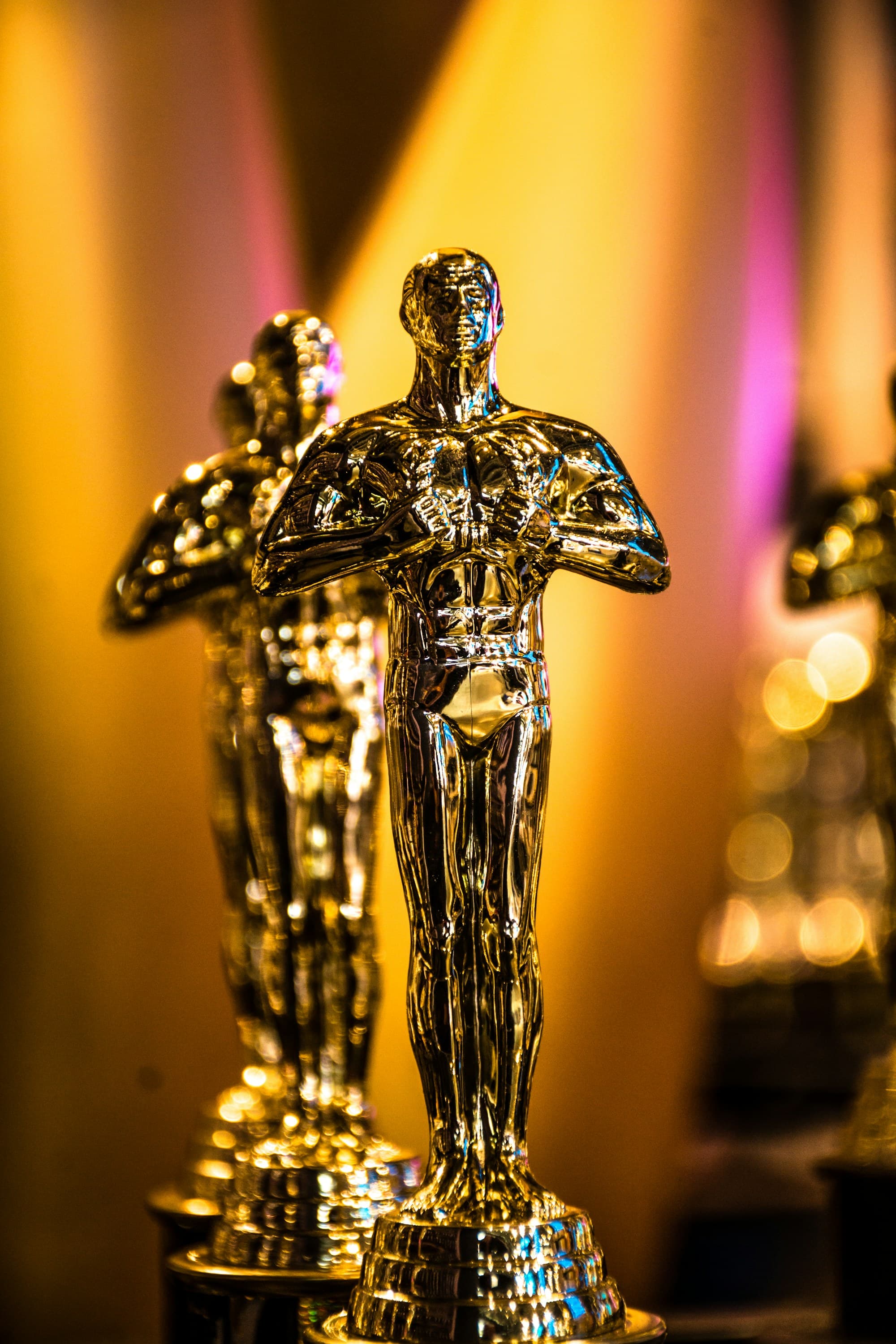 A golden statuette displayed under a spotlight