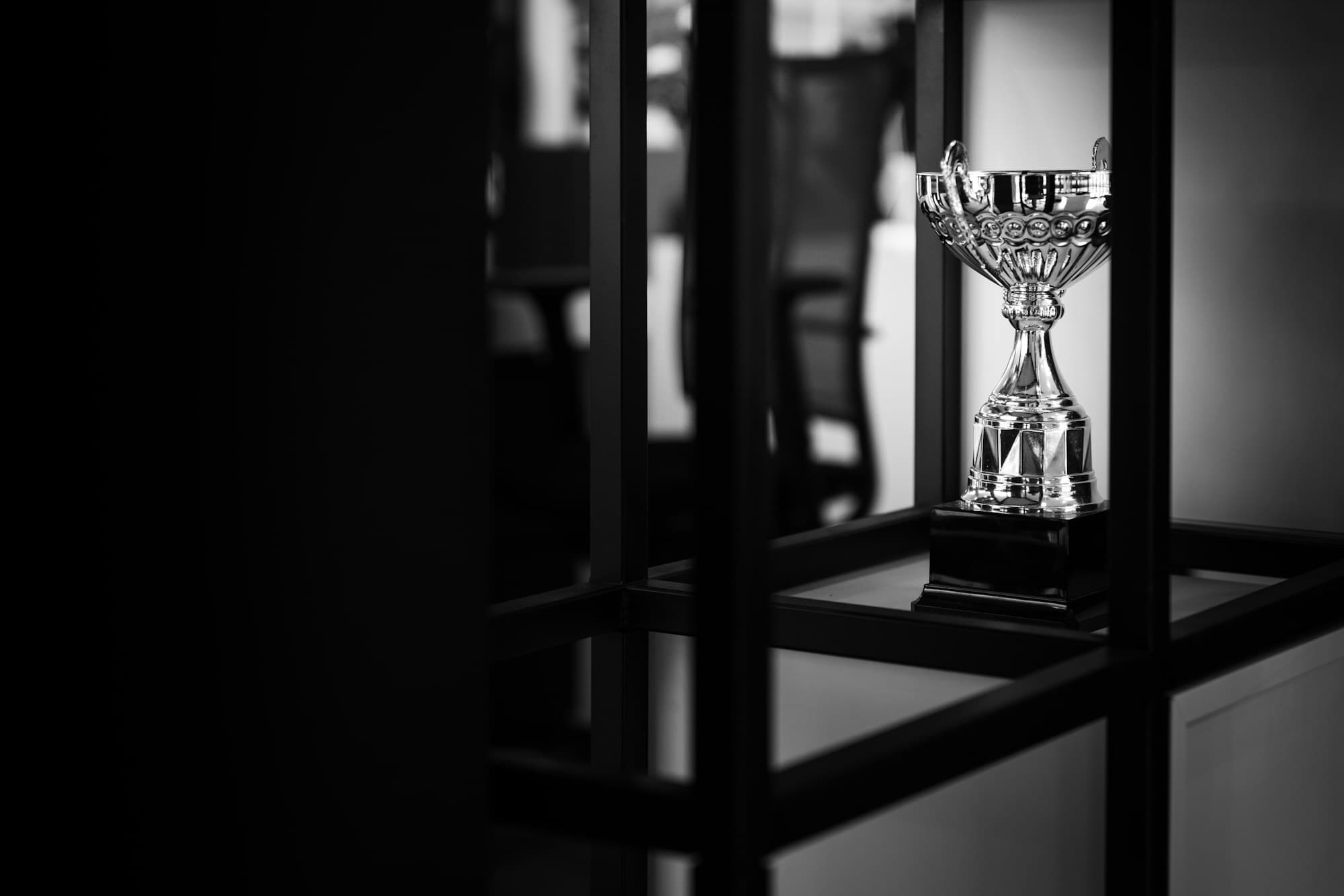 A silver trophy displayed on a table at an awards ceremony