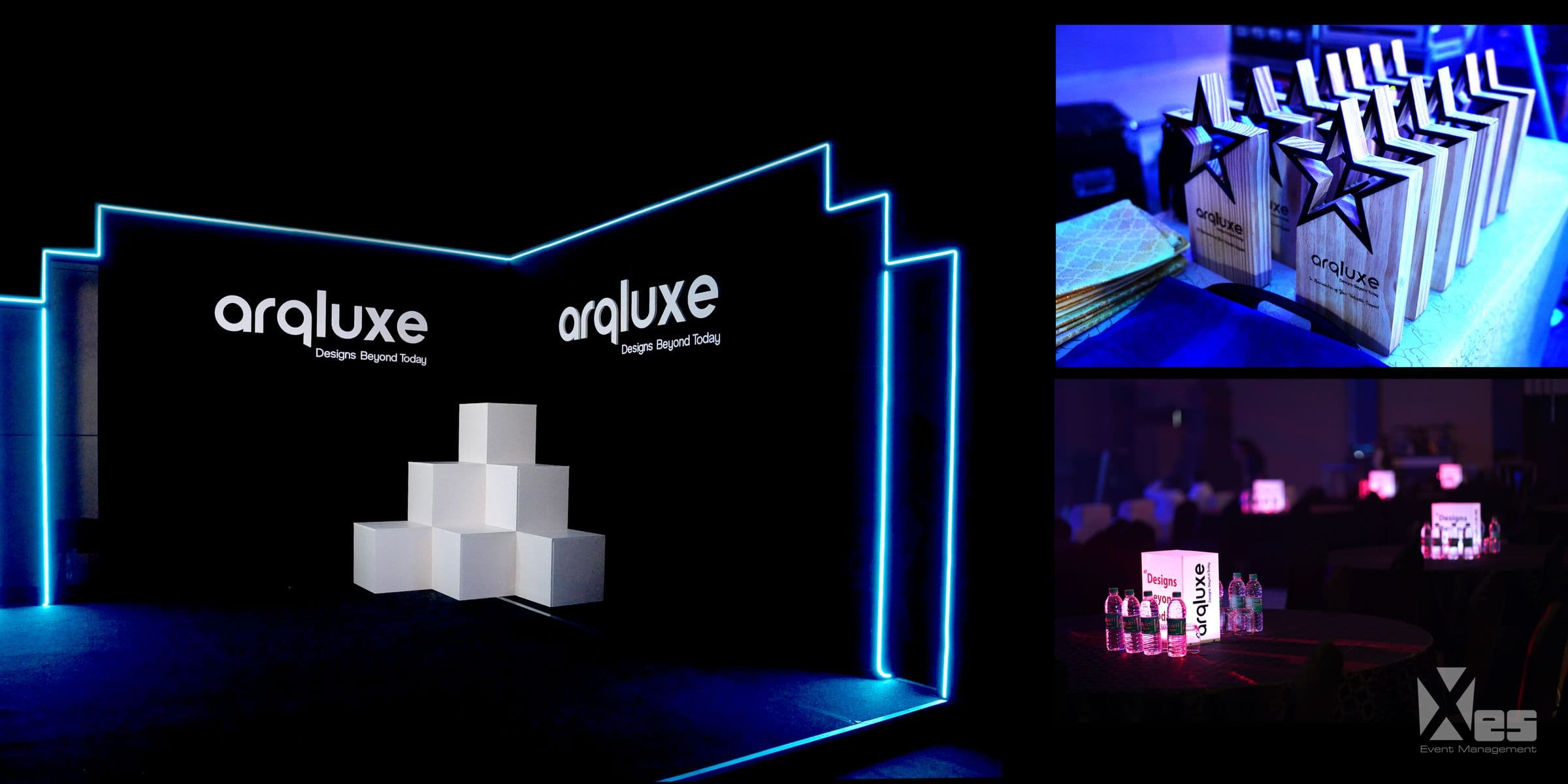 A blue-lit product launch set with branded displays for Arqluxe