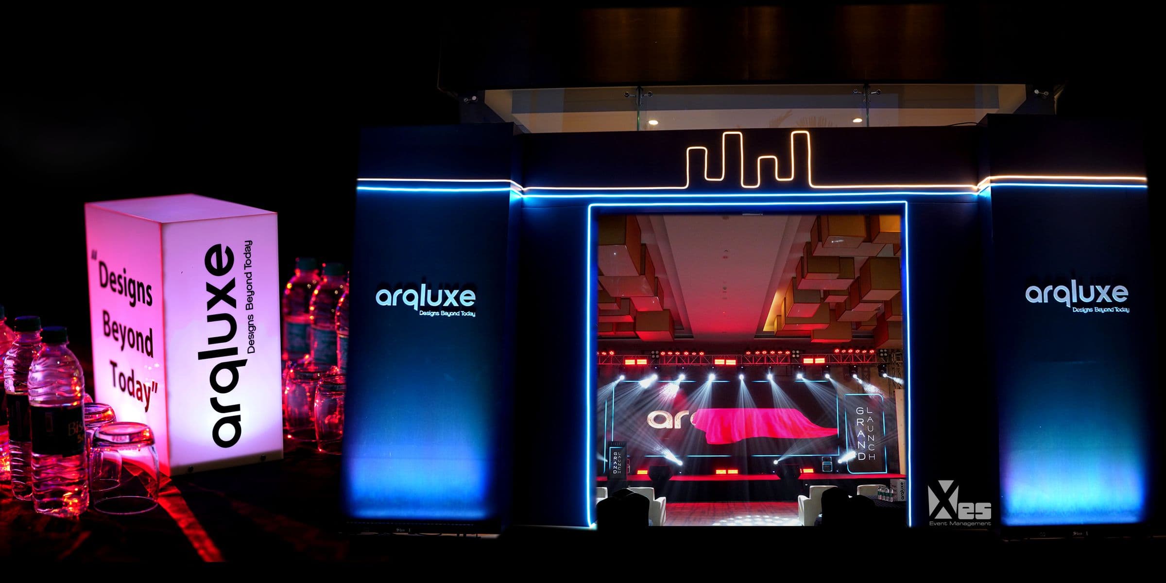 The launch stage for Arqluxe, framed in blue light