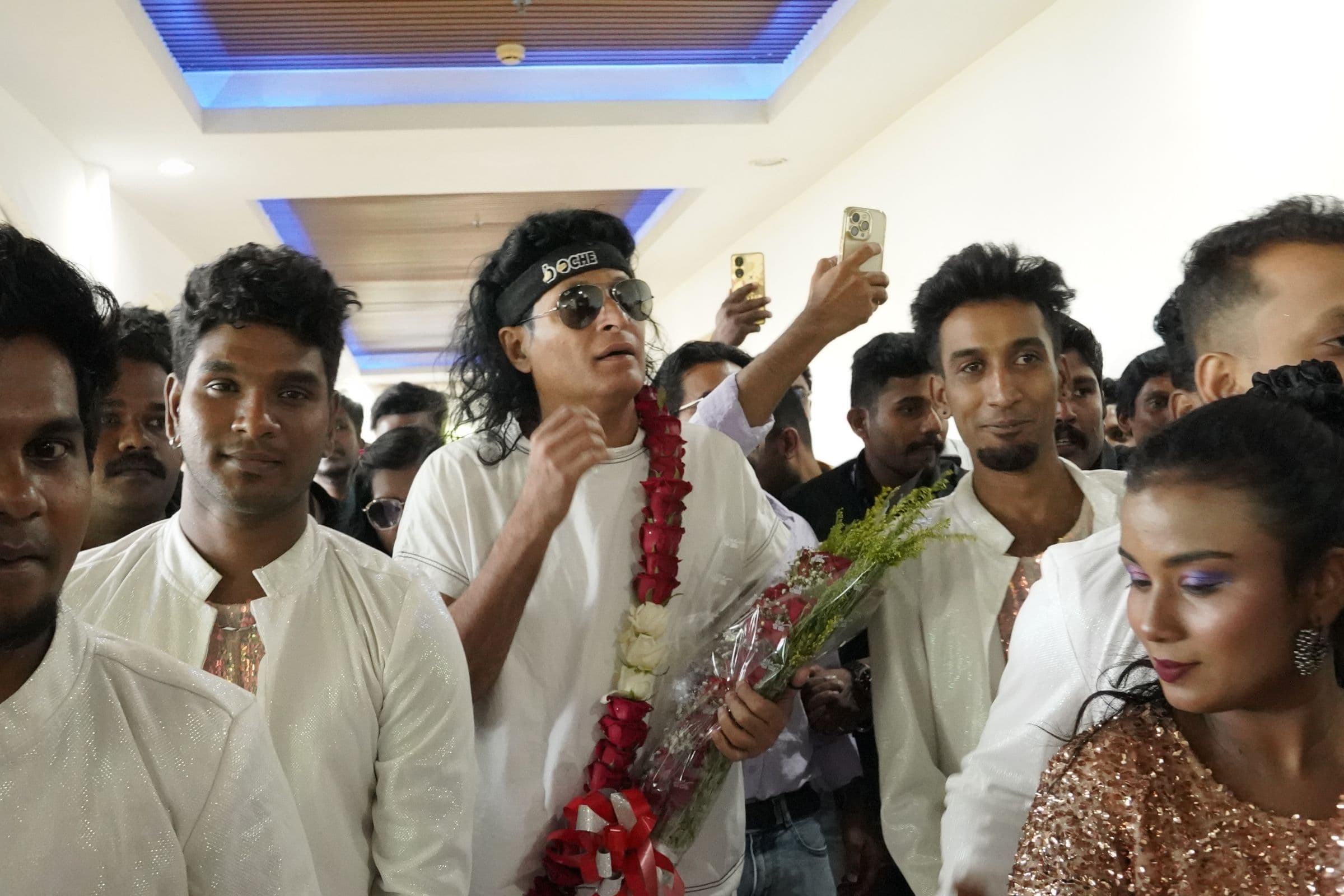 A guest is welcomed by students taking selfies at a Brilliant Study Centre event