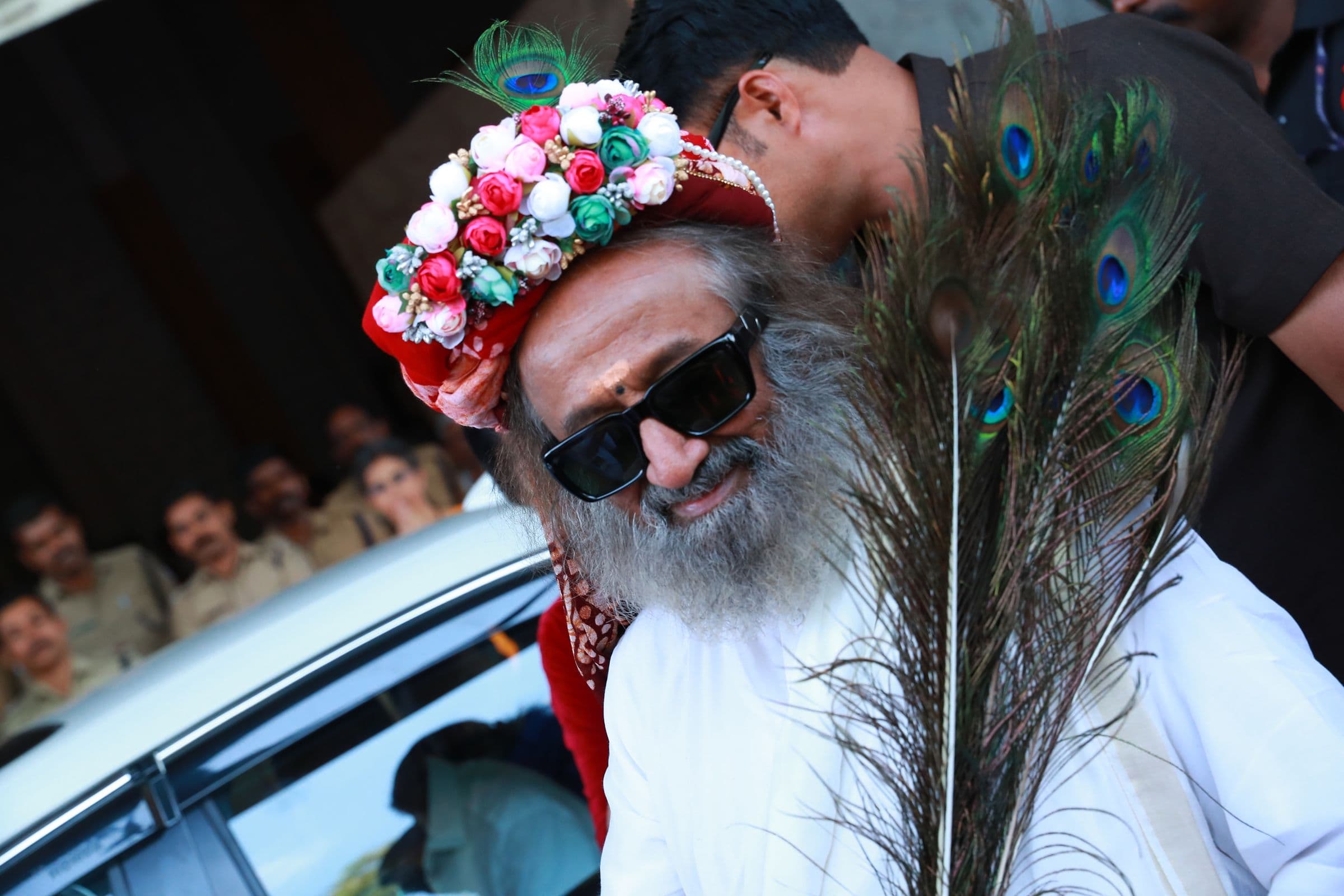 A guest in a traditional headdress arrives at a Brilliant Study Centre event