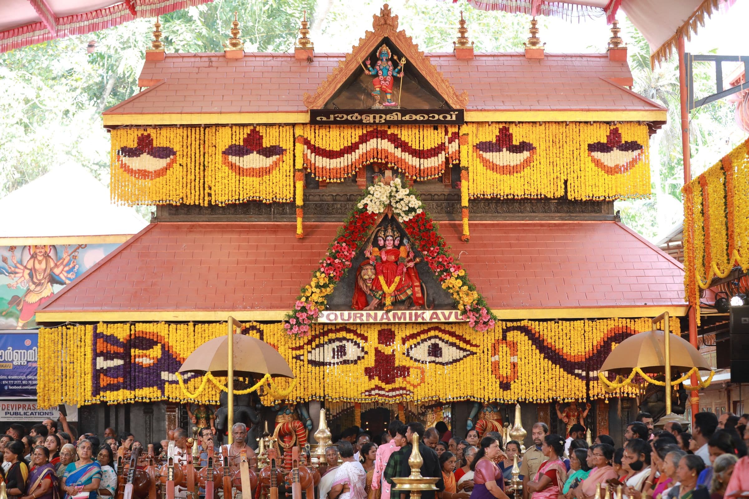 A traditional temple-style stage set dressed with marigolds