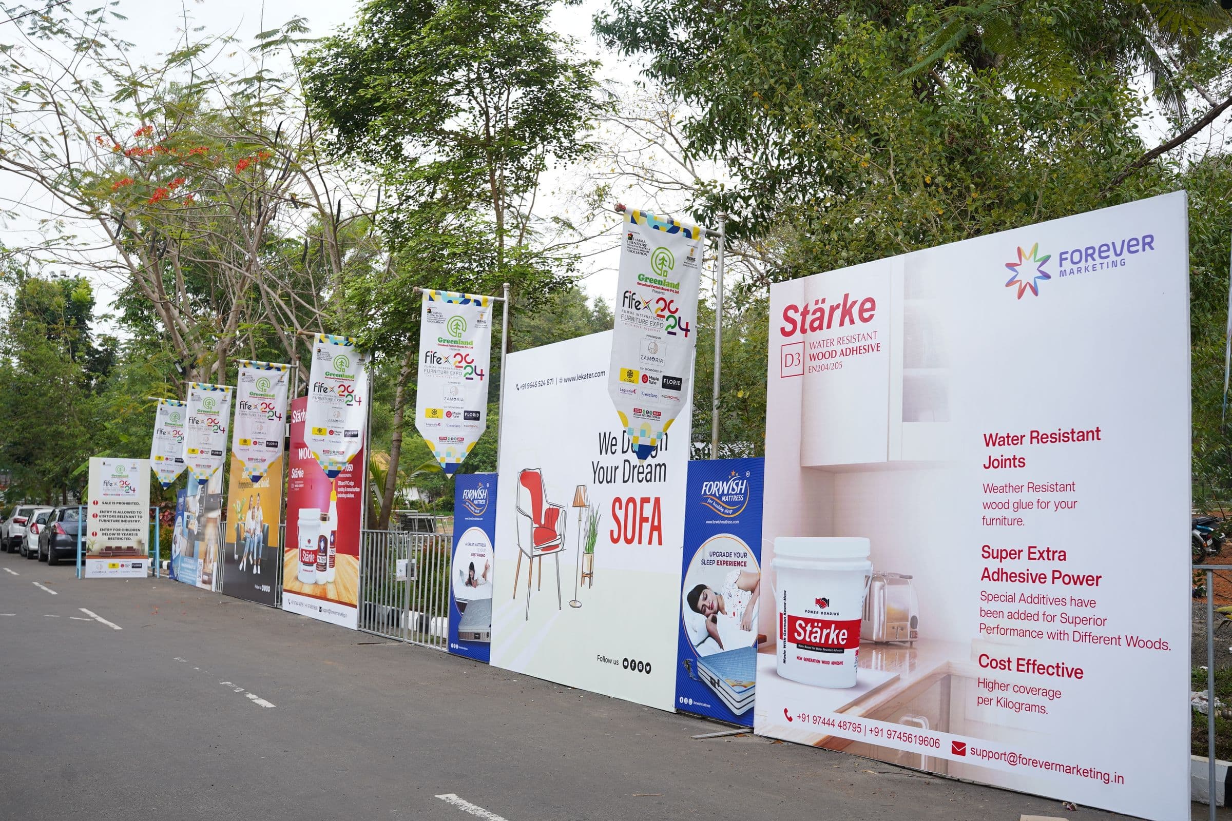 A walkway of exhibitor hoardings leading into FIFEX