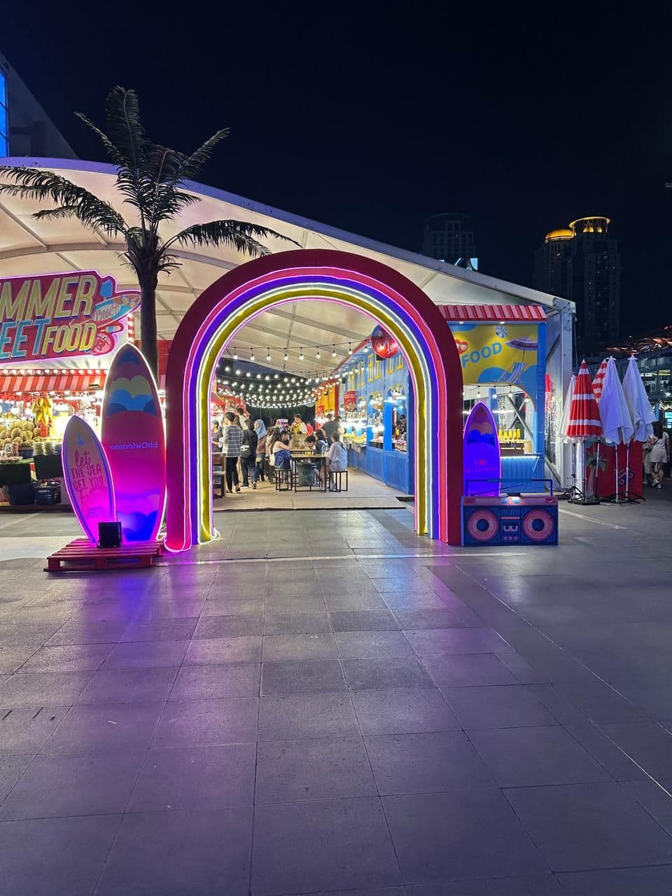 An illuminated floral arch at an event abroad