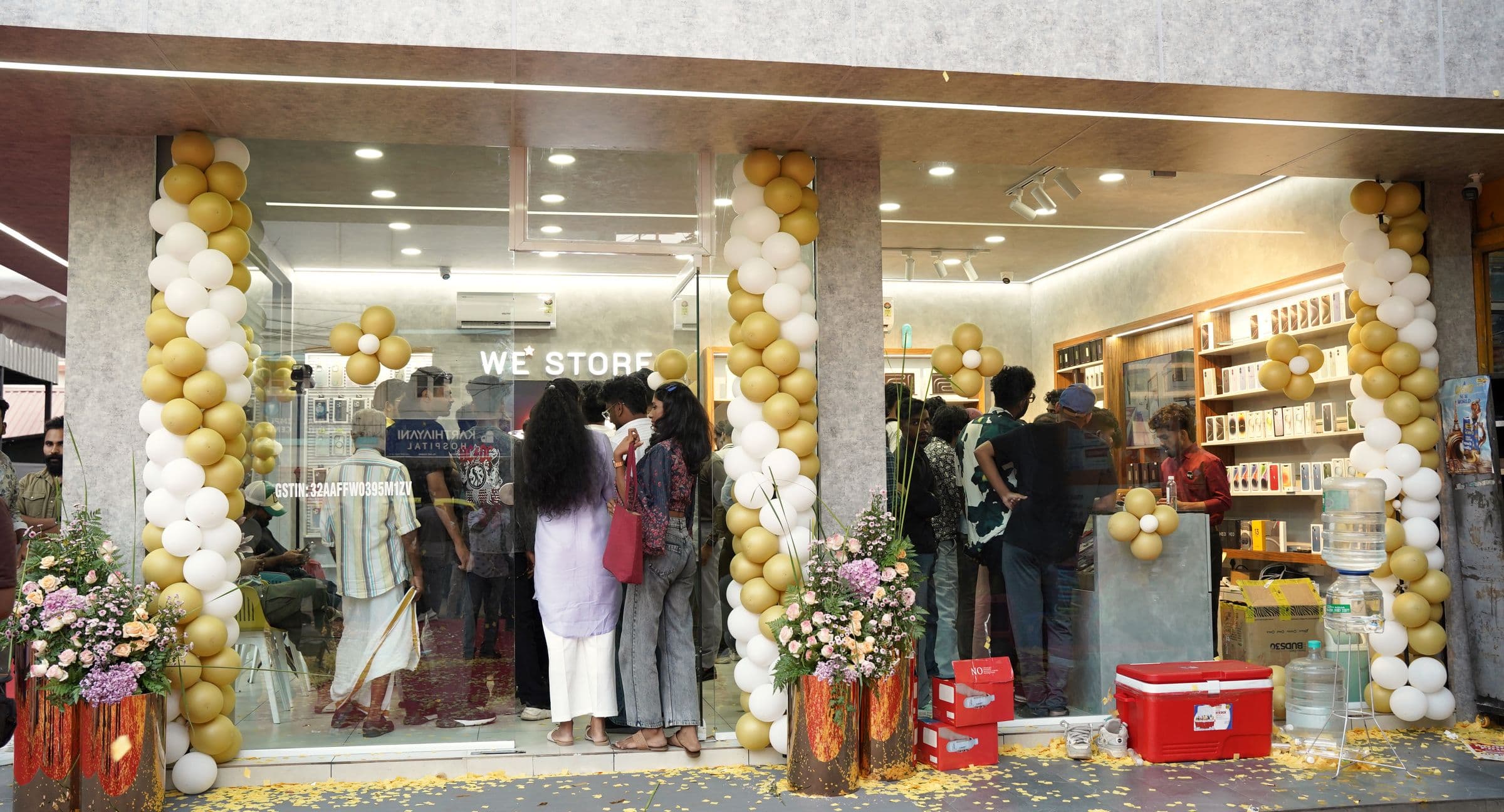 A store launch dressed with gold and white balloon installations