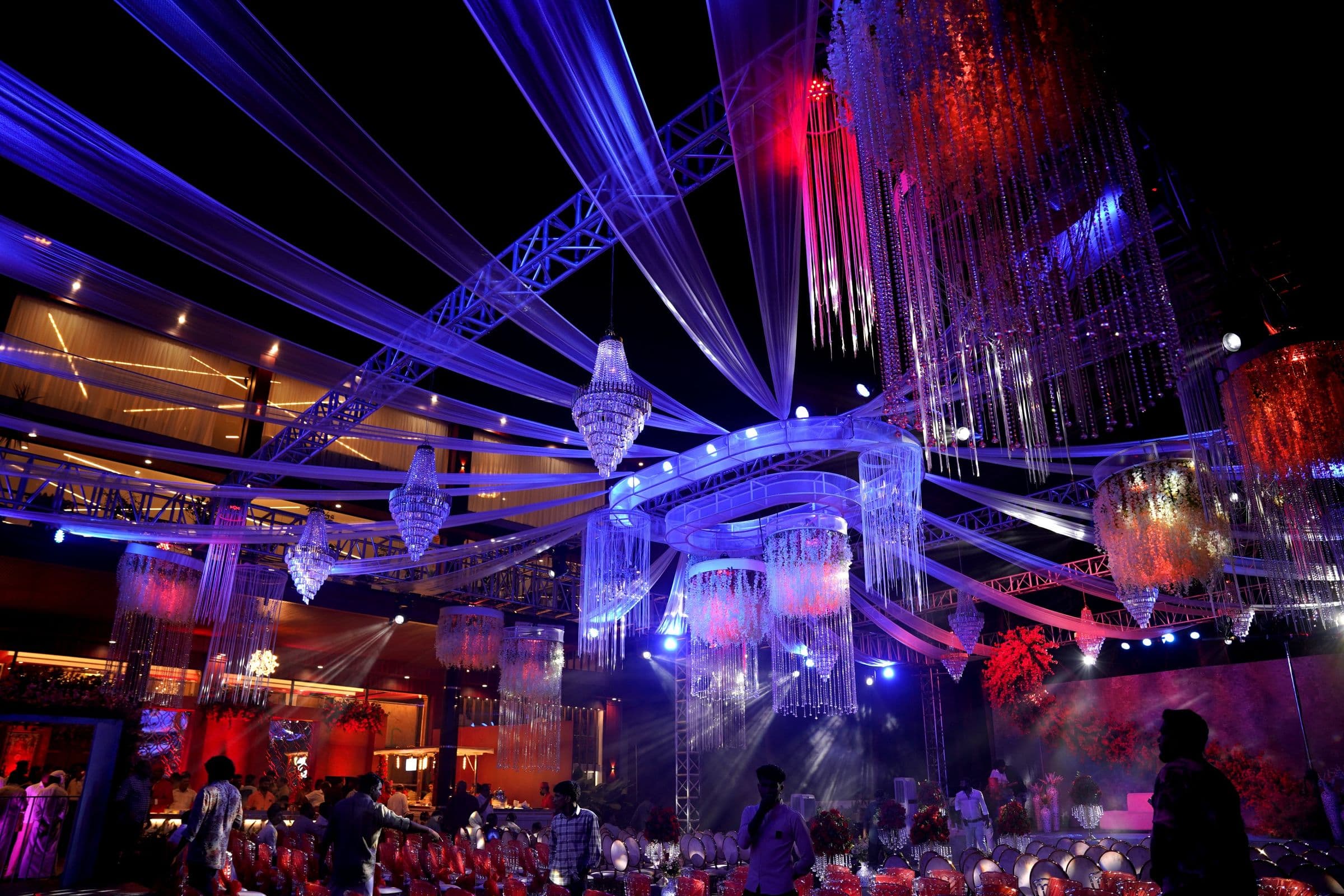 A wedding reception transformed with crystal installations, lasers and blue stage lighting