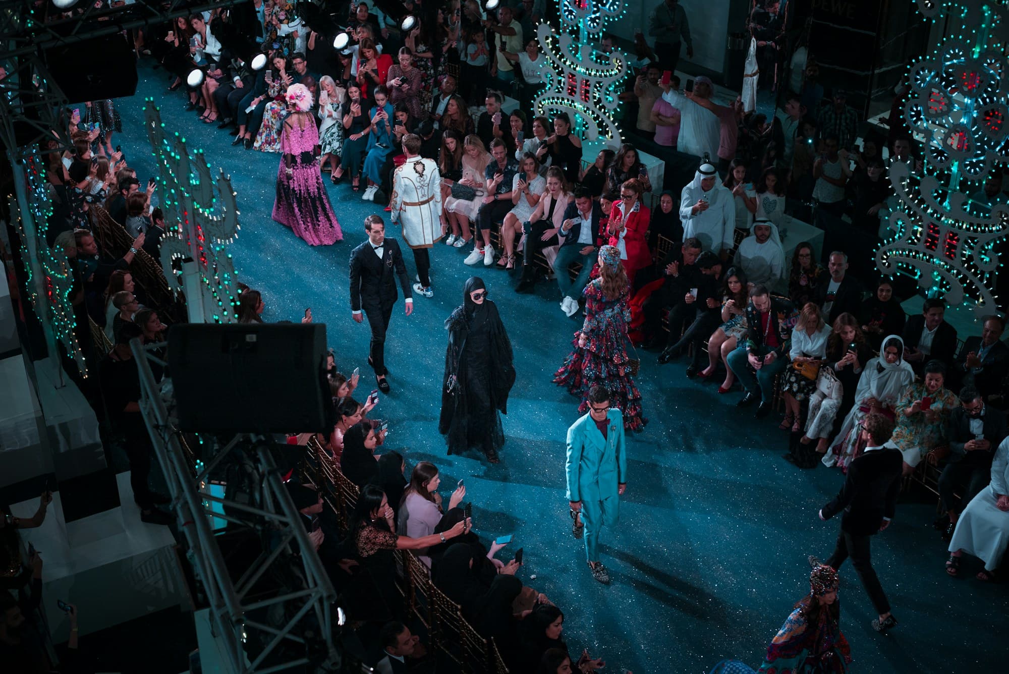 Models present on stage during a fashion show