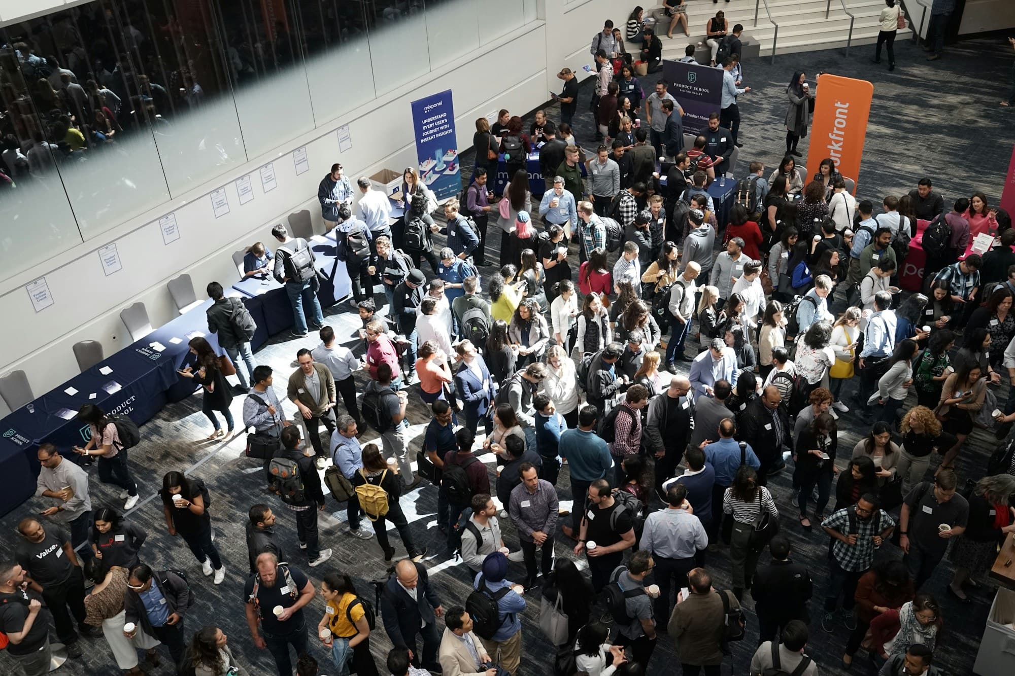 A crowd of guests gathered in a building lobby