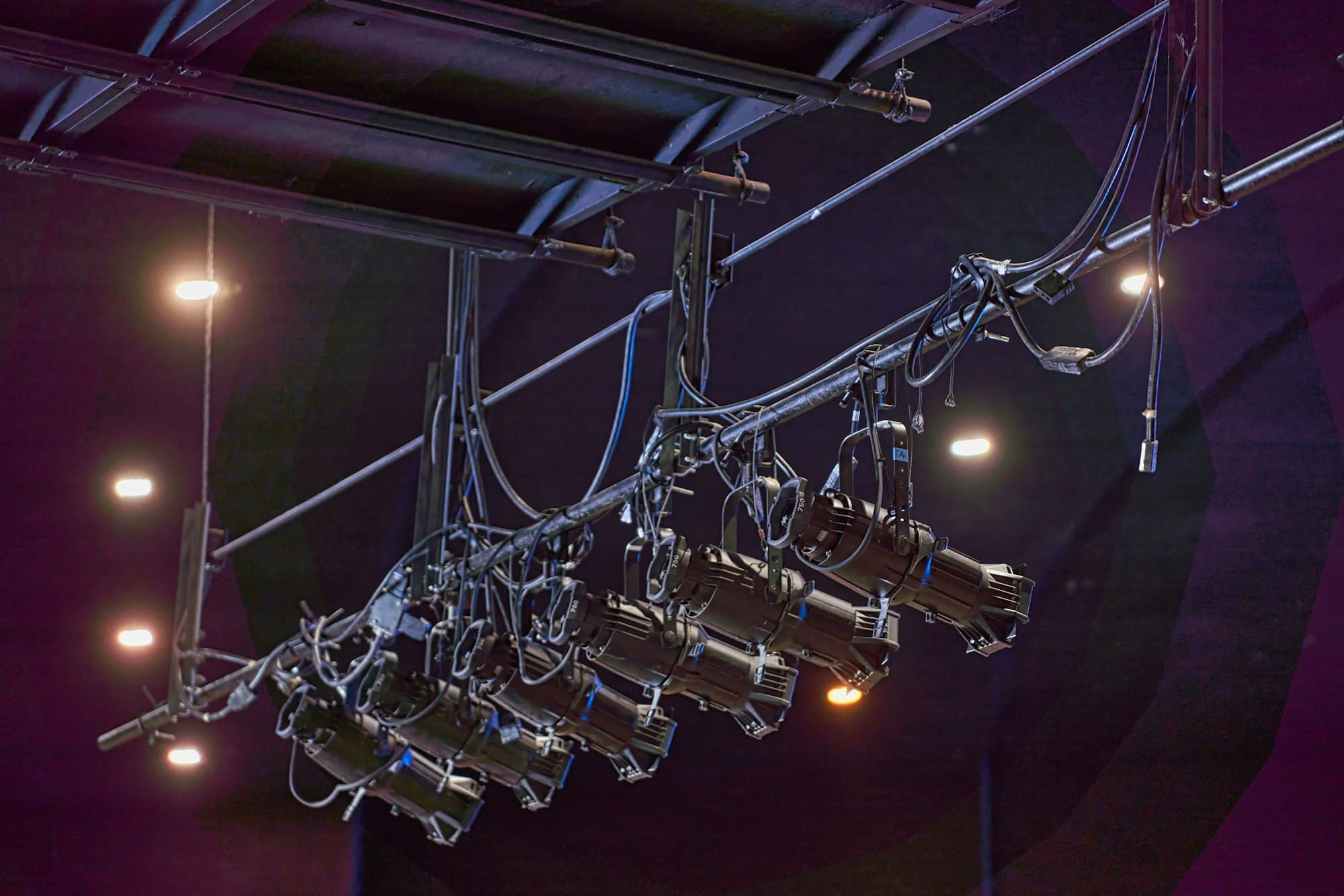 Rows of stage lighting fixtures hang from a rig