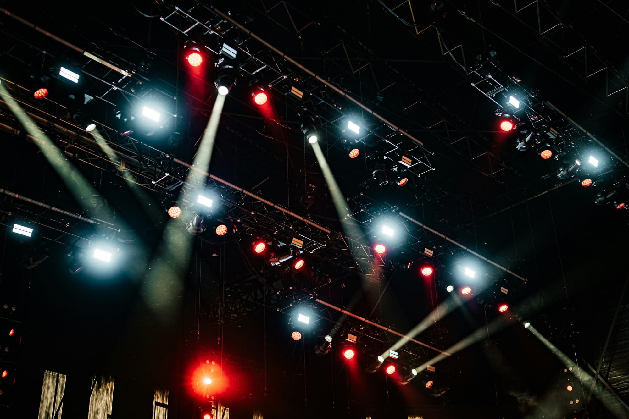 Festival stage lighting glows against the night sky
