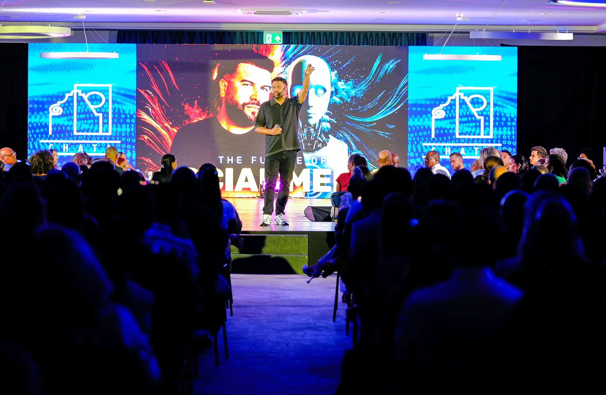 A keynote speaker presents to a full industry conference audience