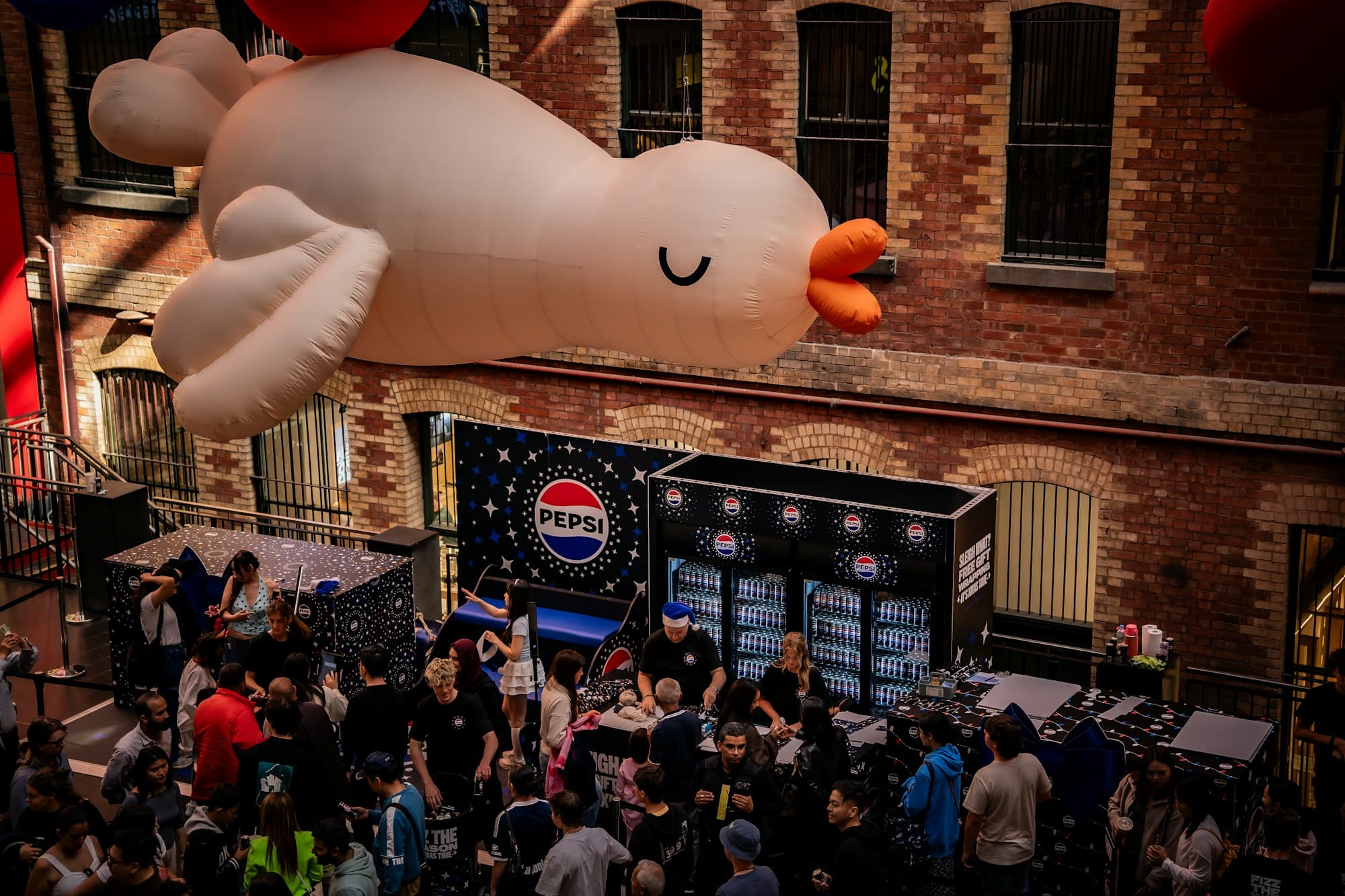 A balloon installation activates a busy mall atrium