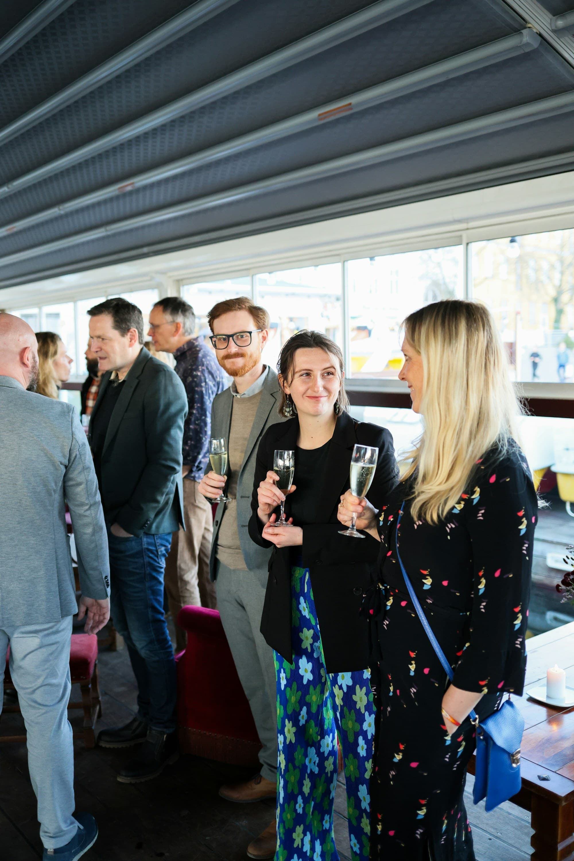 Guests hold glasses while networking at a reception