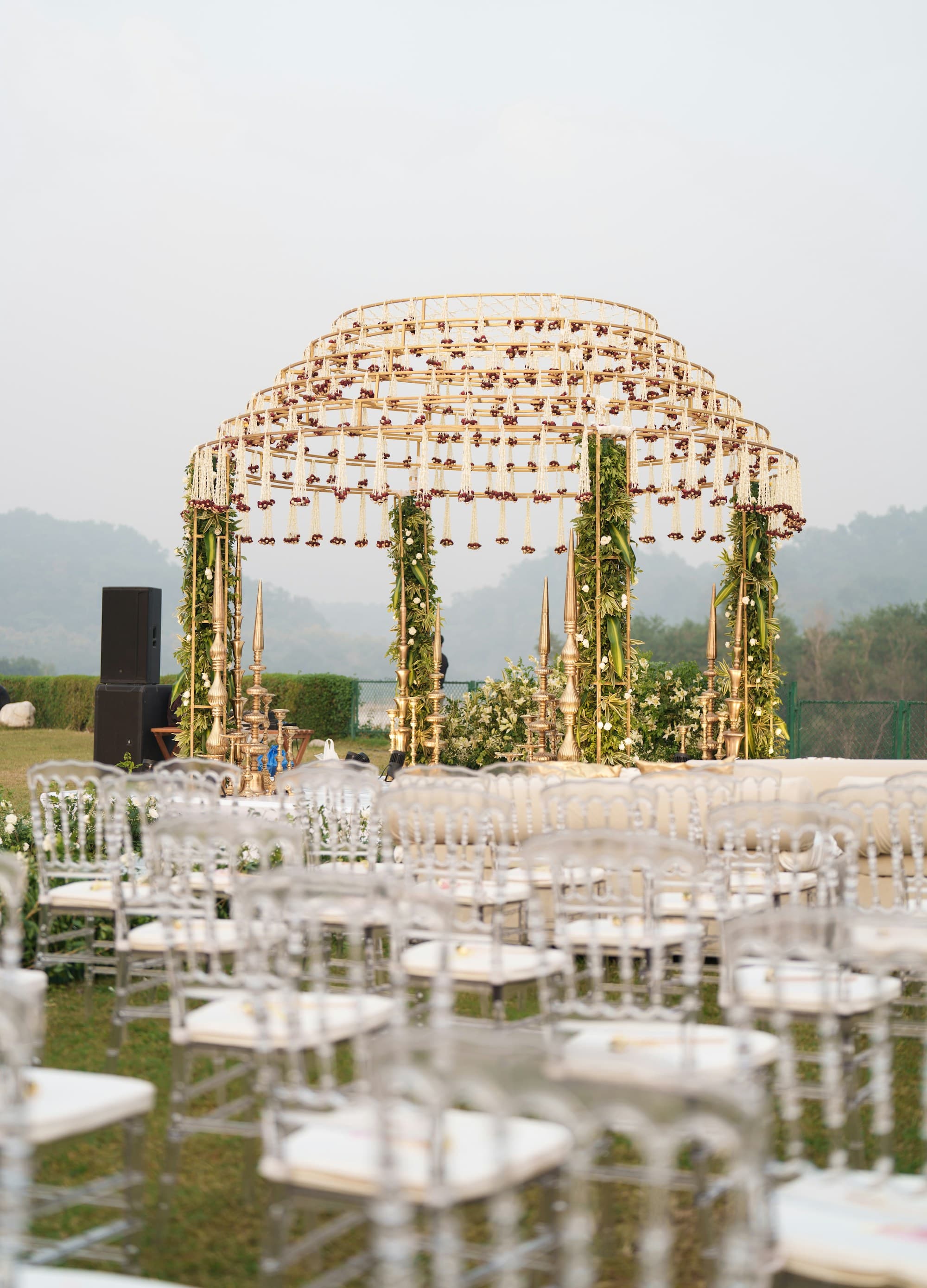 An elegant outdoor wedding ceremony setup with rows of decorated seating